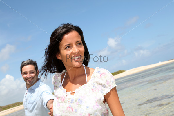 Cheerful couple walking by the sea