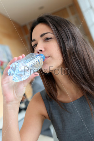 Portrait of office worker drinking water from bottle