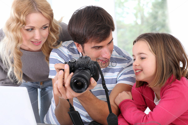 Family looking at pictures on camera screen