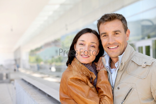 Smiling couple standing outside the airport