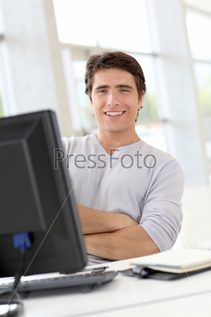 Relaxed man working in office