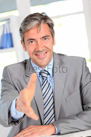 Businessman giving handshake to client