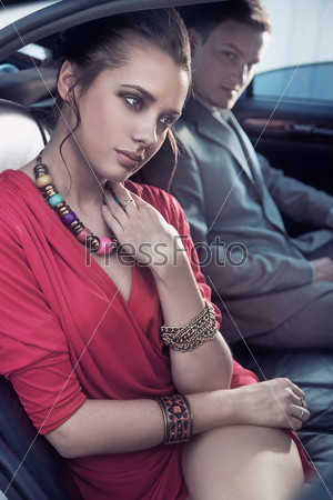 Handsome elegant couple traveling a luxury vehicle