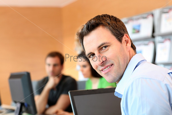 Man sitting in office in front of laptop computer