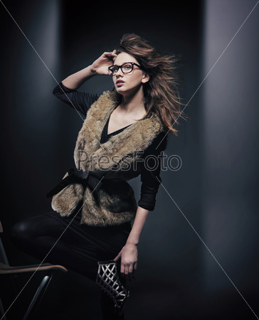 Fashion style photo of young brunette wearing glasses