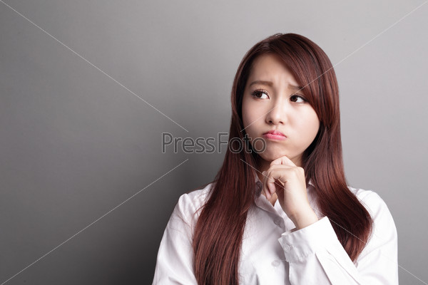 Thinking business woman and look copy space isolated on grey background with finger at face, asian beauty