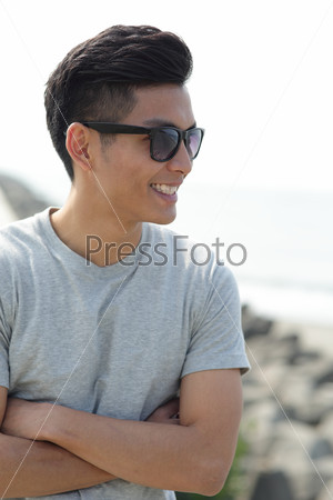 Fashion young man with his fashionable sunglasses, asian male
