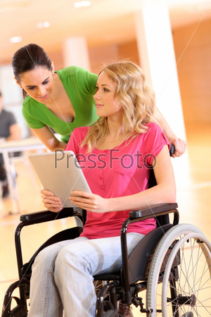 Handicapped person at work with electronic tablet