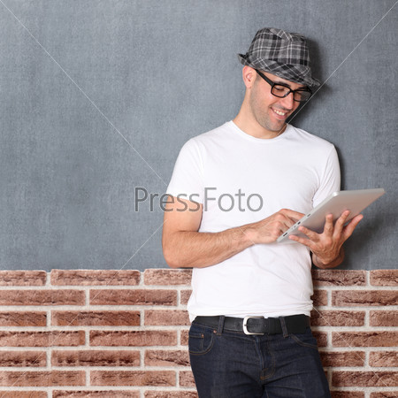 Stylish guy using electronic tablet