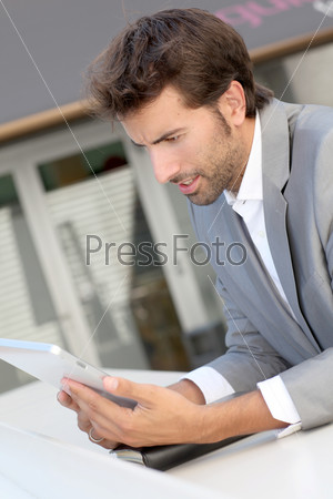 Businessman standing outside offices building