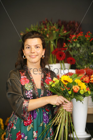 Female florist making a bouquet of flowers