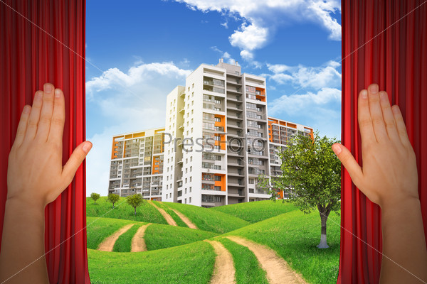 Humans hands on curtains and city under cloudy blue sky with road and trees