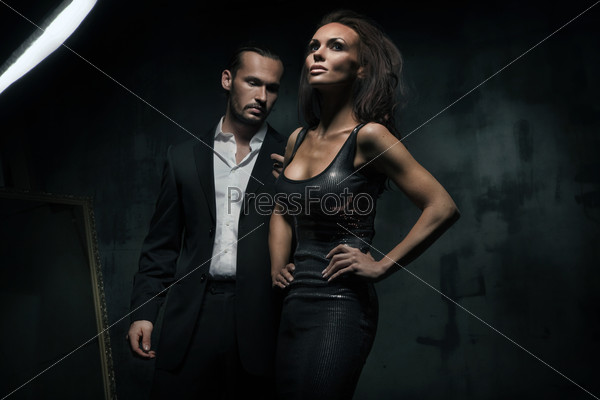 An attractive couple on the dark background