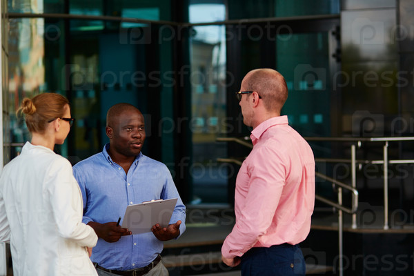 African businessman voicing his ideas upon financial data to colleagues at outdoor meeting