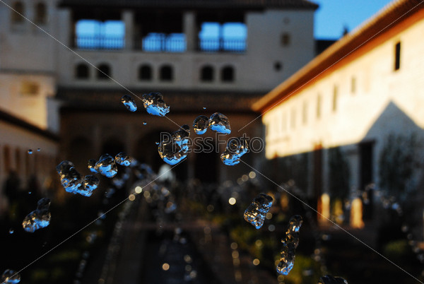Fountain in a yard of historical building, closeup of waterdrops