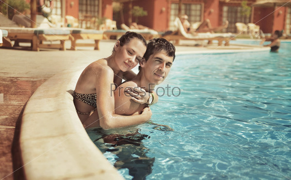 Young couple having fun in a swimming pool