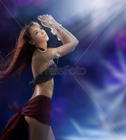 Young pretty girl dancing in a nightclub