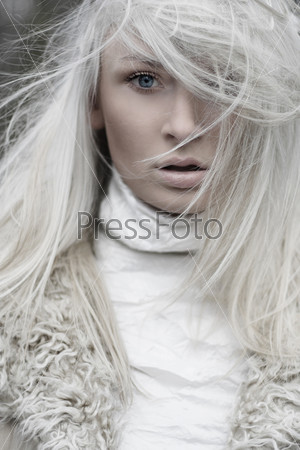 Portrait of a beautiful girl wearing white fur