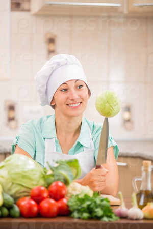 chef in the kitchen with cabbage on the knife