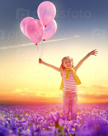 little girl holding pink balloons