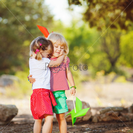 Cute happy children playing in spring filed
