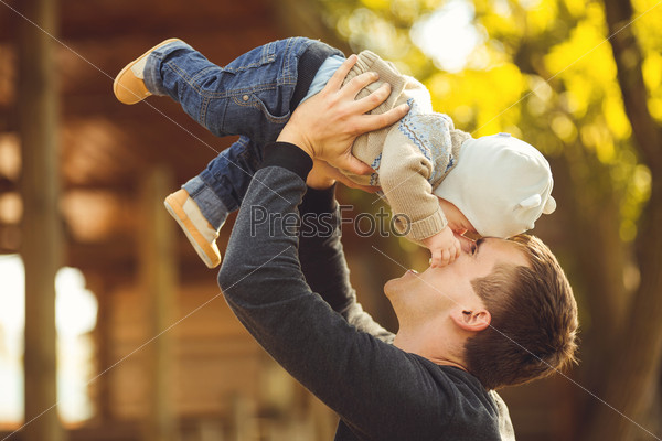Mother and her child enjoy the summer in park. Outdoors.