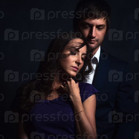 Curly brunette girl and handsome guy in a suit perfect romantic couple