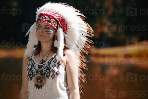 Young woman in war bonnet headdress of American Indian