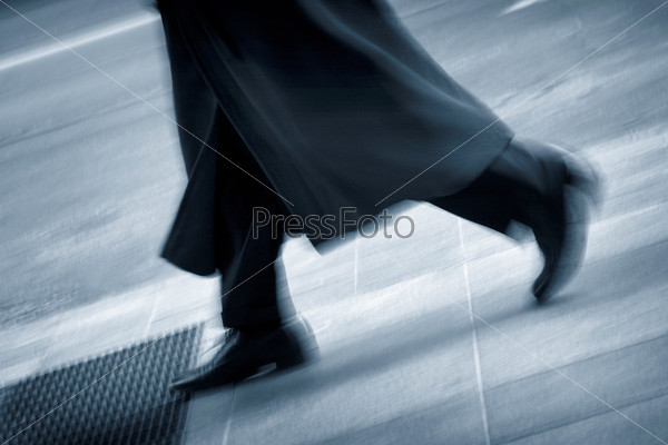 Lower body of a businessman passing by