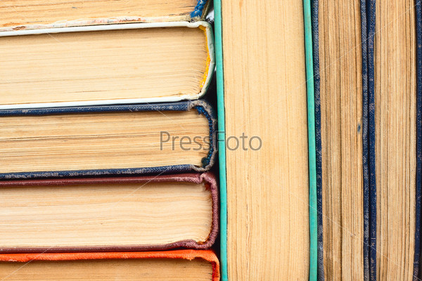 old yellowed books in a stack in the background