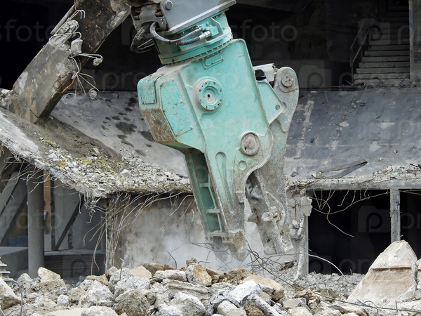 Closeup image of a concrete demolition machine at work, stock photo