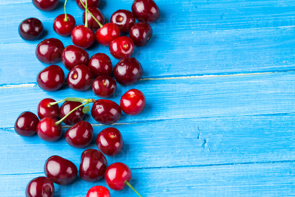 Cherries on a blue wooden background