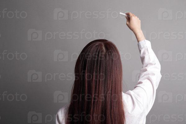 Back view of business woman writing something on gray background, great for your design or text, asian