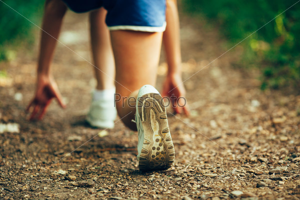 closeup woman runner shoe on park trail