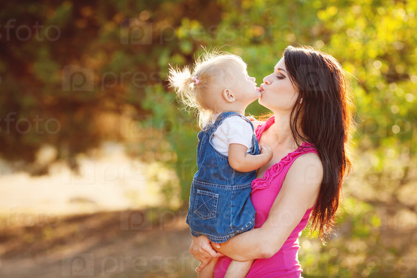 Mother and daughter playing outdoors in summer