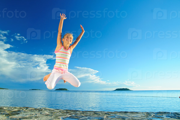 Happy jump girl and sea in the background of blue sky