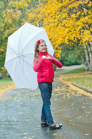 Cute girl with white umbrella walking