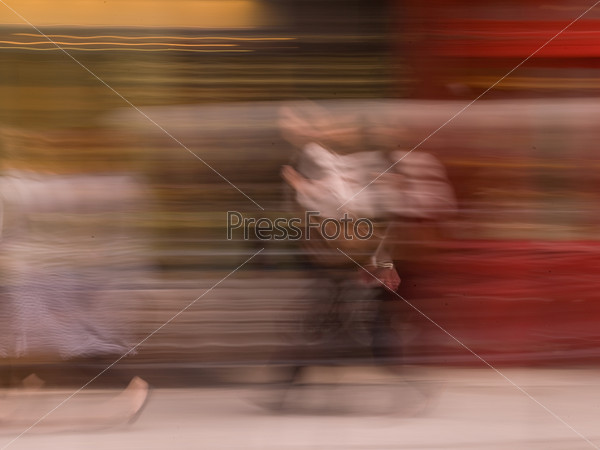 Blurred image of a person walking in Paris France