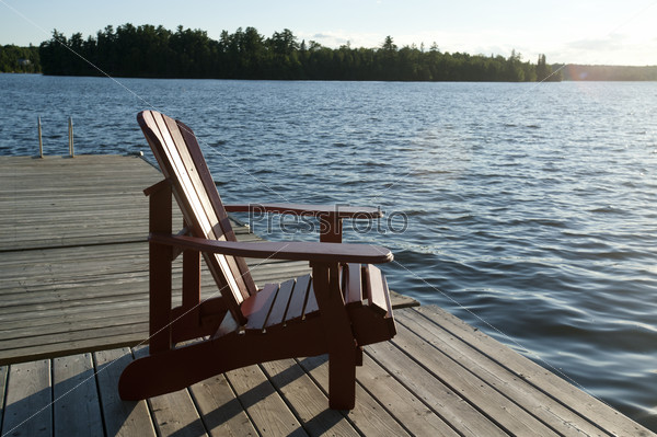 Chair on the dock overlooking the lake at Lake of the Woods, Ontario