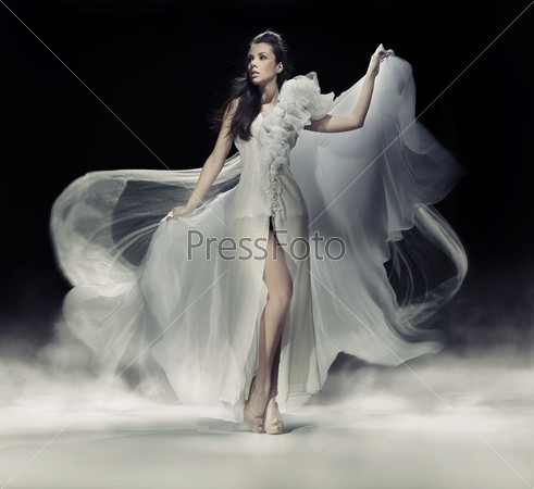 Sensual brunette woman in white dress