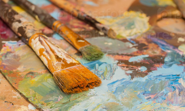 Oil paints and brushes can be used as background, stock photo