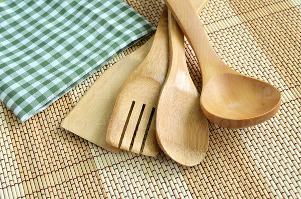 Wooden cooking utensils on wood background