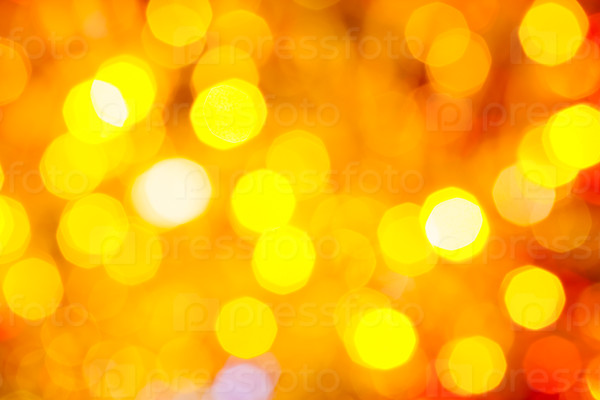 abstract blurred background - yellow and red shimmering Christmas lights bokeh of electric garlands on Xmas tree