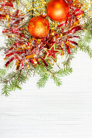 Christmas greeting card - border from star and two orange Xmas baubles and tree branch on blank paper background