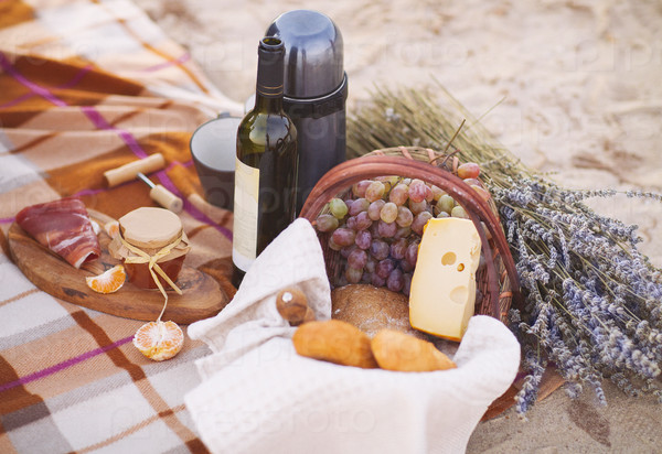 Autumn picnic by the sea with wine, grapes, bread,  jam and cheese