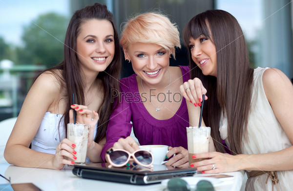 Three young women having coffee break