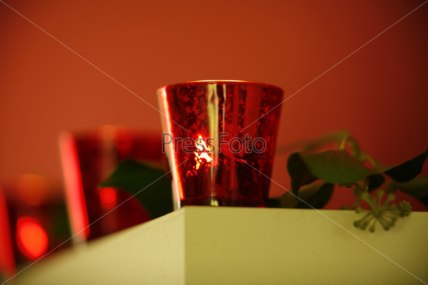 Christmas decorations: low angle view on a candle in red candle holder
