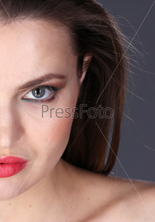 Portrait of young attractive woman. Half face