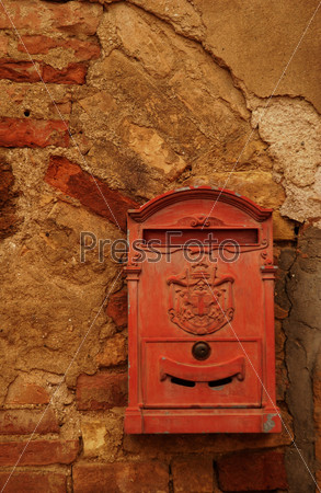 A red mail box on a wall, Sun Gimignano, Tuscany, Italy,