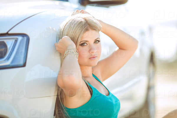 Young pretty lady with a modern luxury car